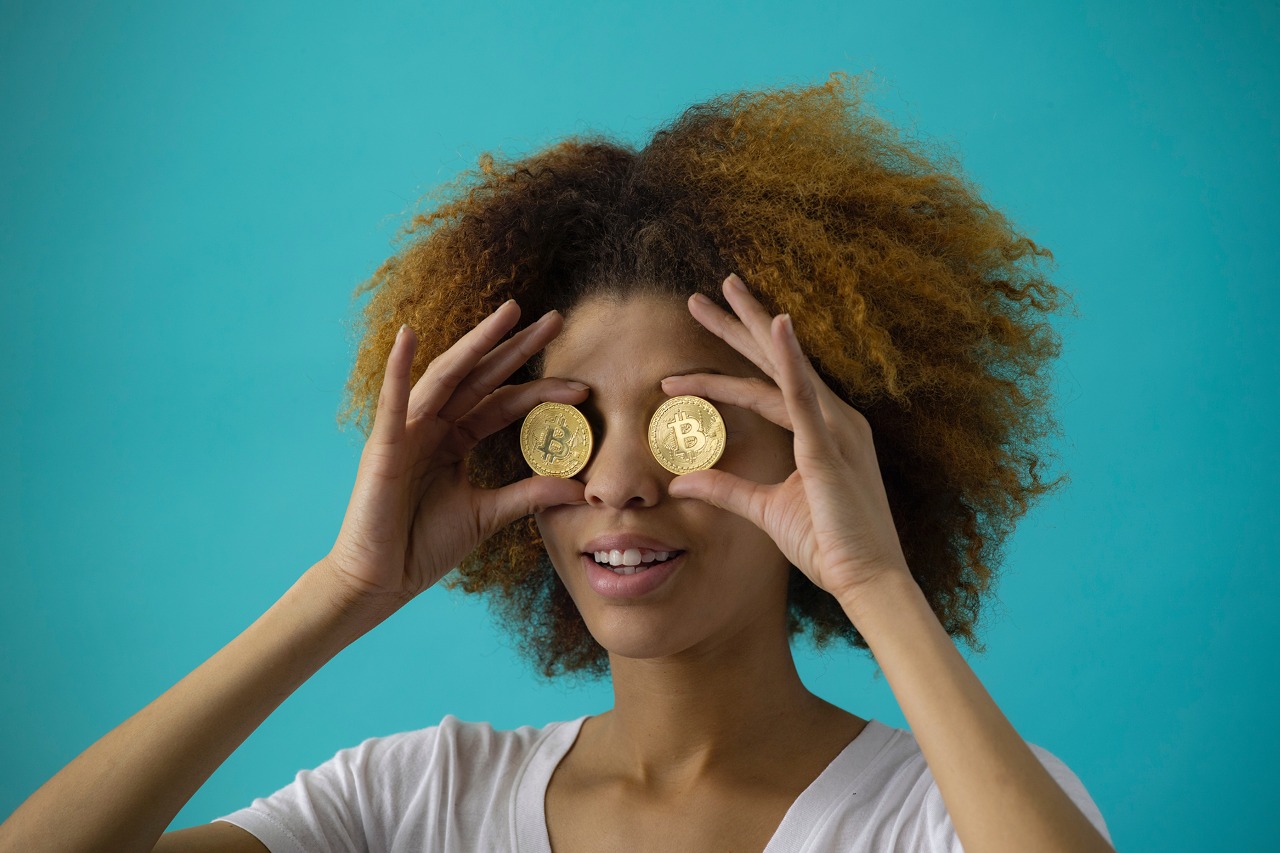 Girl holding coins on her eyes